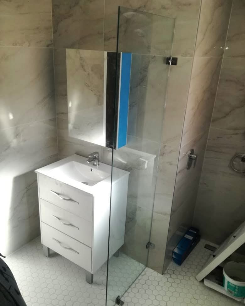Frameless shower enclosure